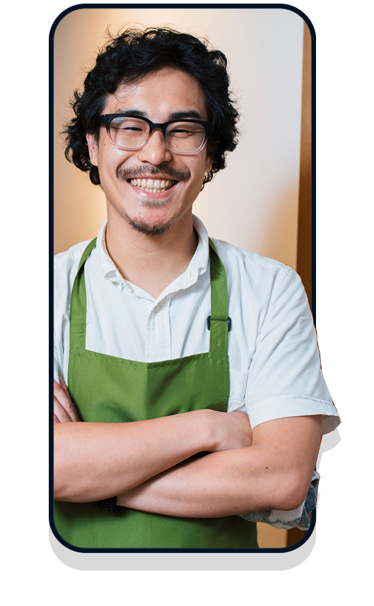 Business owner in white shirt and green apron in mobile frame